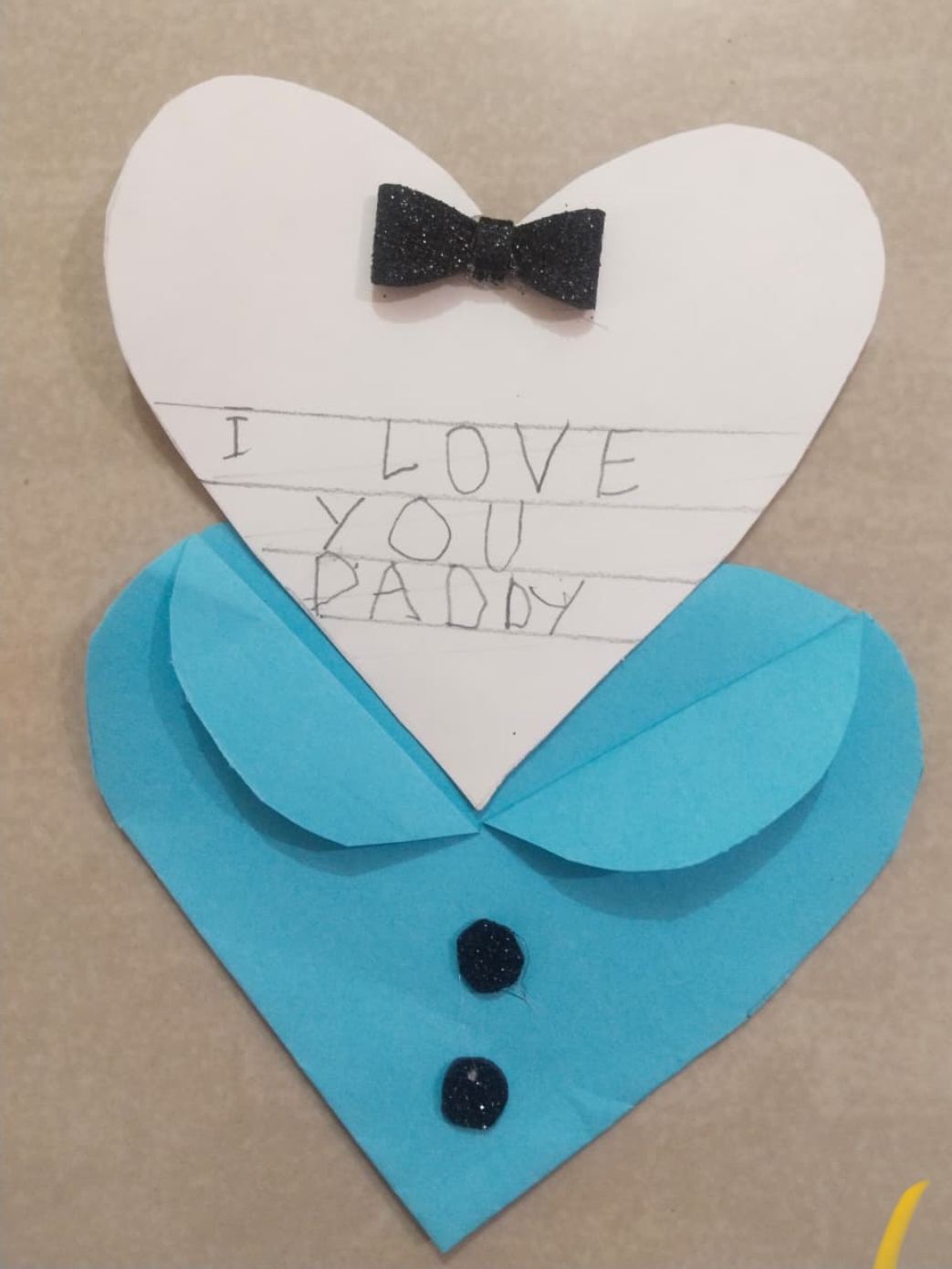 UKG - Child presenting heart-shaped card