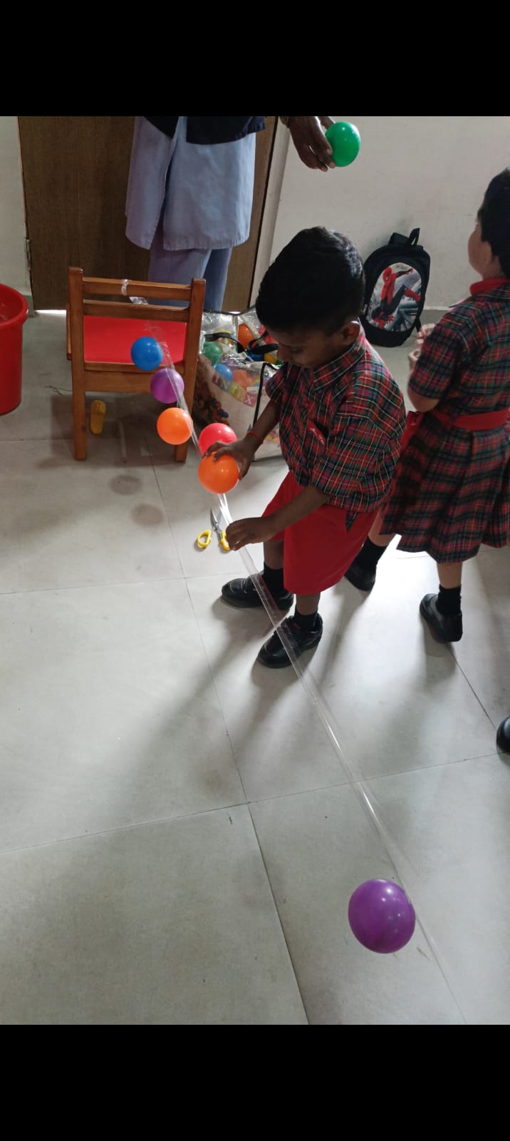 Carefully aligning balls on tape strip