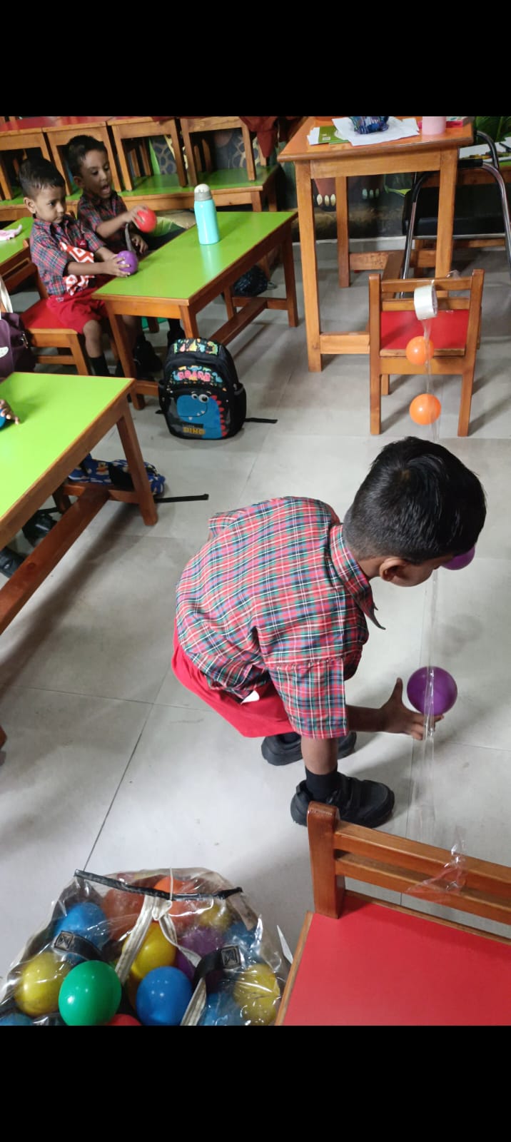 Selecting balls from bag to attach to tape
