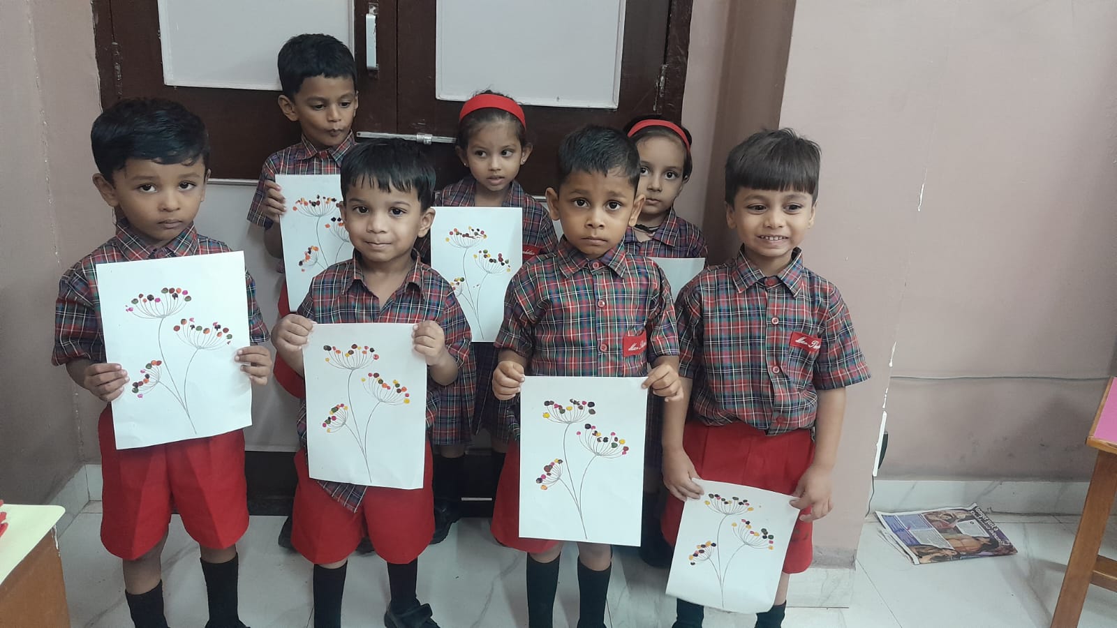 LKG - Classroom boys holding fingerprint flowers sheets