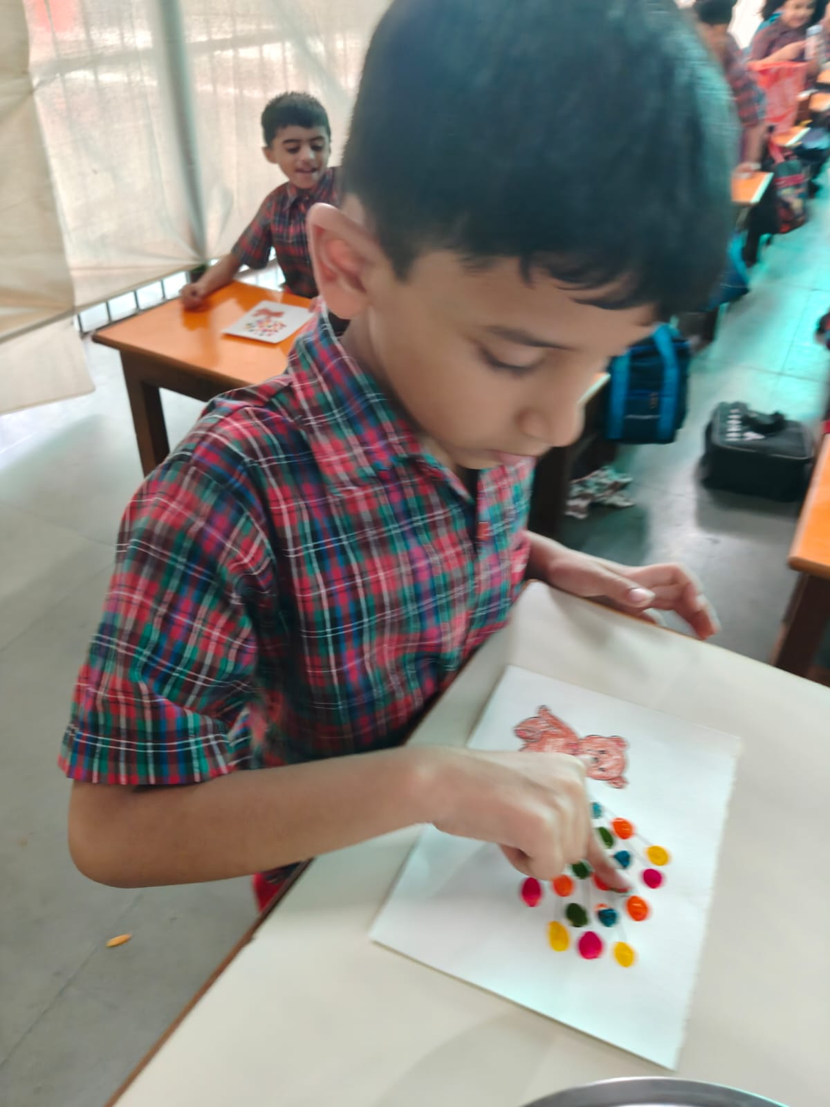 UKG - Boy using inkpad for fingerprint balloons art