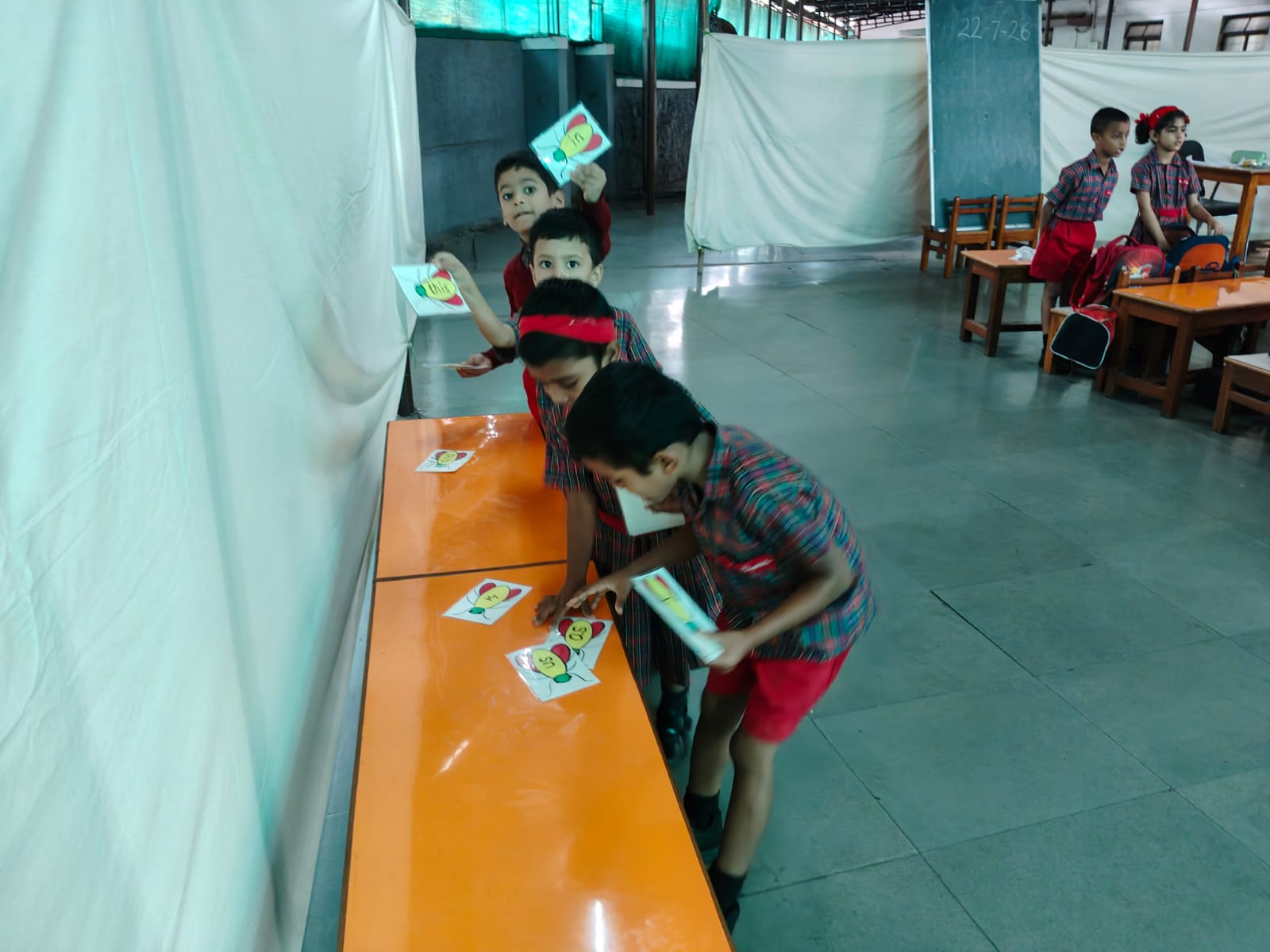 UKG - Child reading word cards on desk