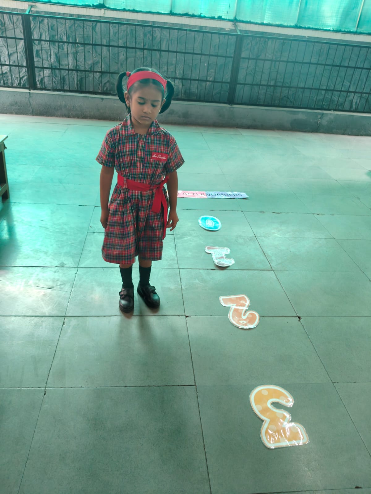 Children doing seated yoga poses on floor mats