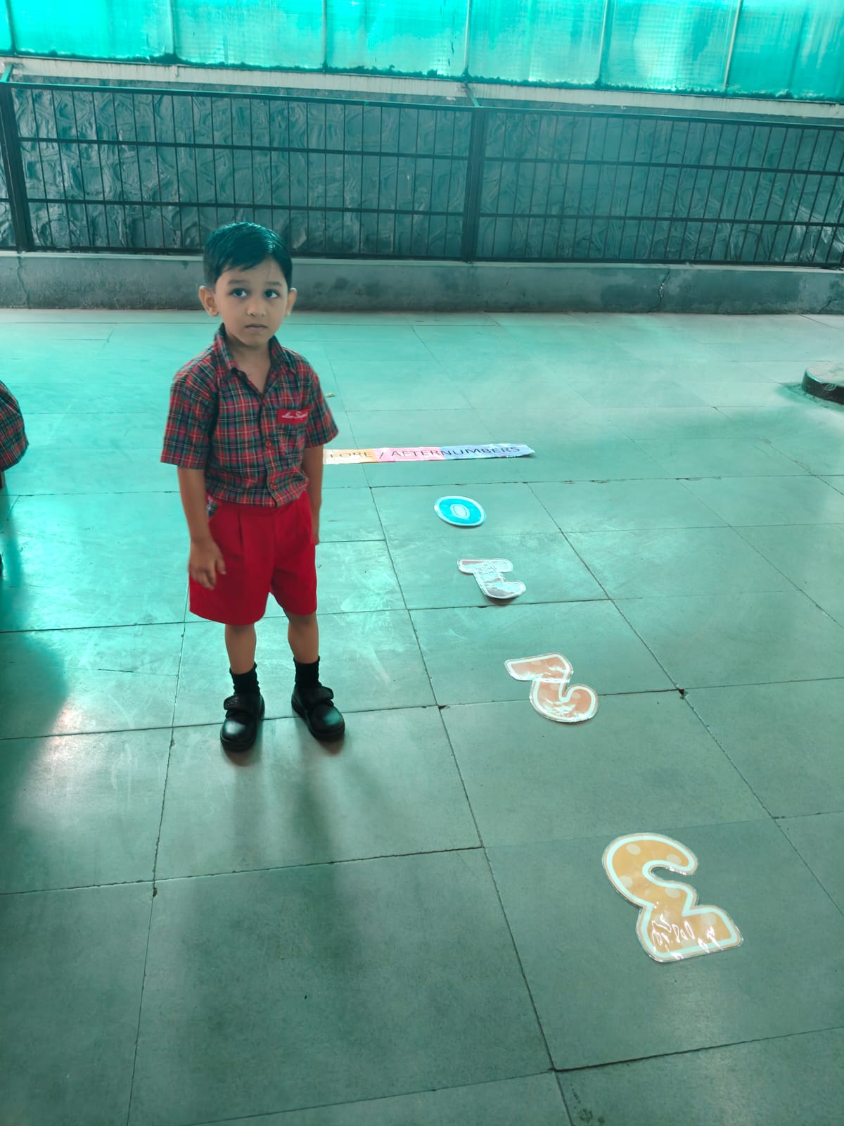 Child jumping to identify preceding and succeeding numbers